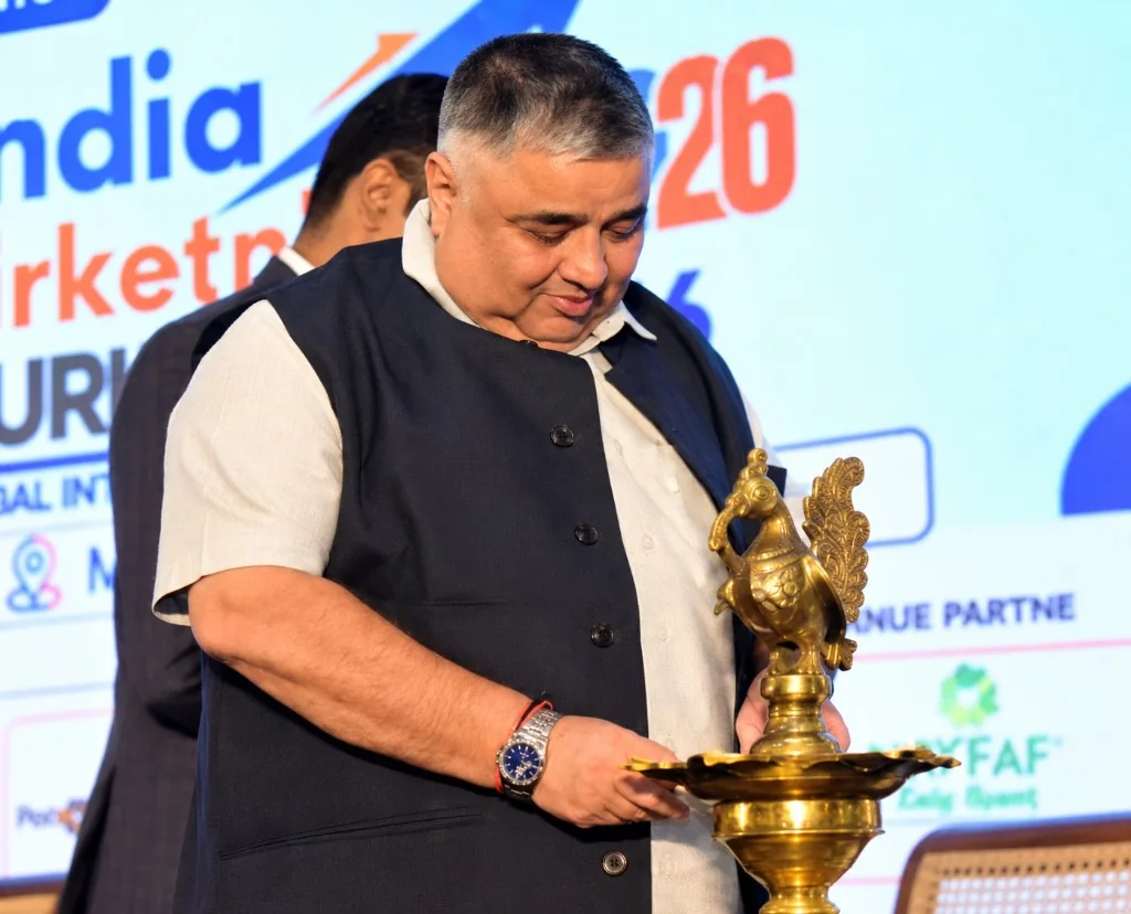 Rajesh Agrawal lighting a ceremonial lamp